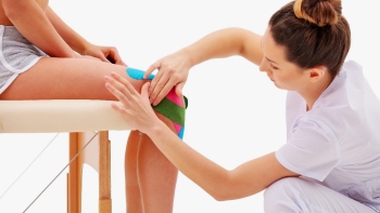 physiotherapist taping and strapping